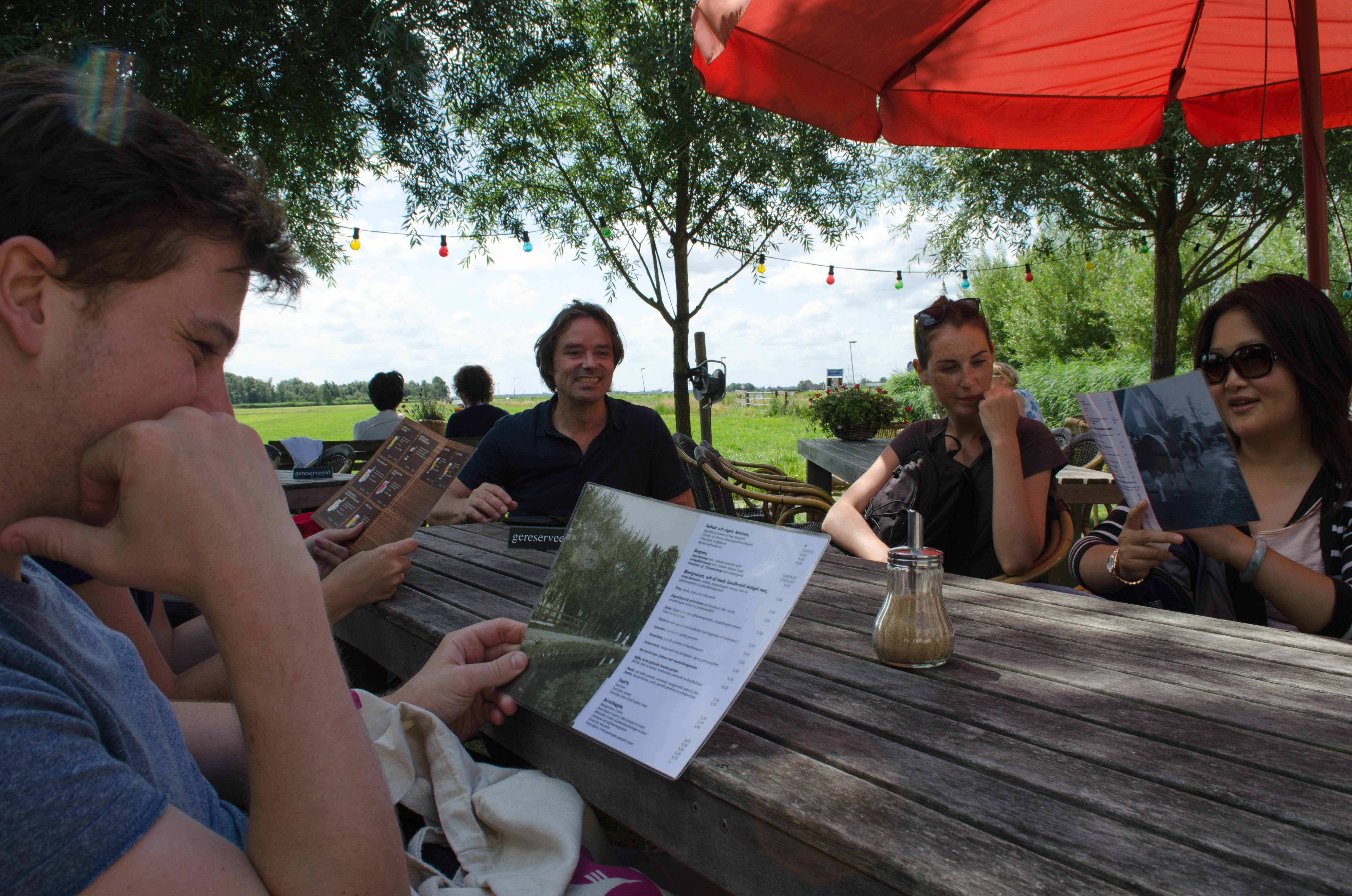 friends from Dutch class enjoy a meal at a brown cafe following a bike trip across the countryside of Holland, just outside Amsterdam-Noord