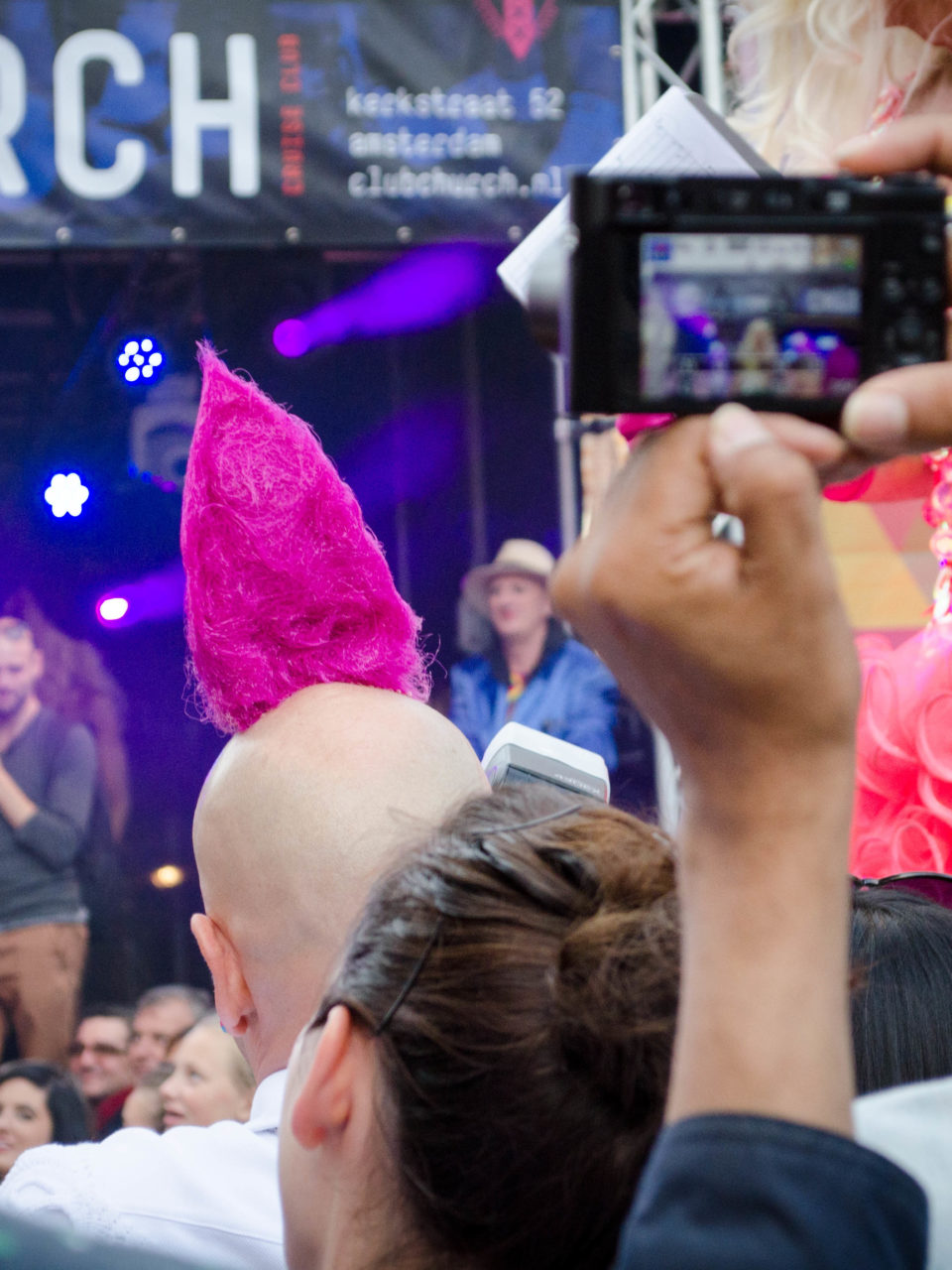 an excellent hairstyle on one of the photographers at the 2016 Drag Queen Olympics celebrating Gay Pride in Amsterdam